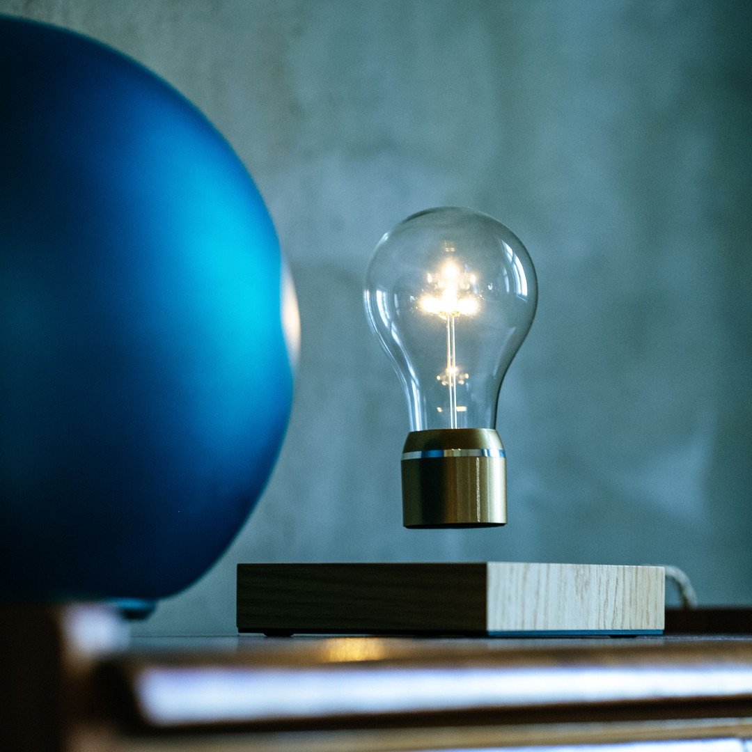 Levitating light bulb Light Edison by Flyte, levitating on a table in an interior setting