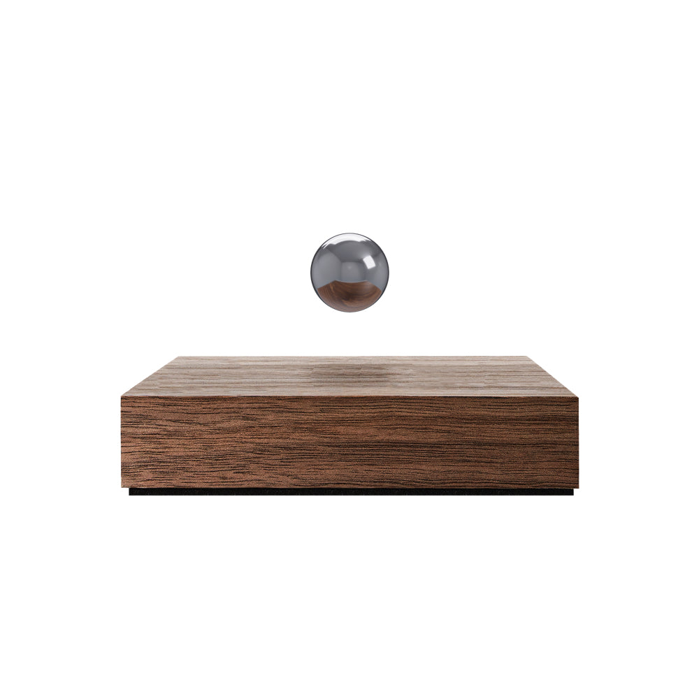 Levitating sphere Buda Ball by Flyte, chrome sphere, walnut base, product photo on a white background