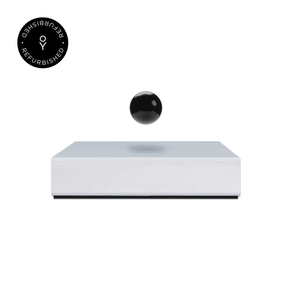 Levitating sphere Buda Ball by Flyte, black sphere and white magnetic base version, product photo on a white background with refurbished tag