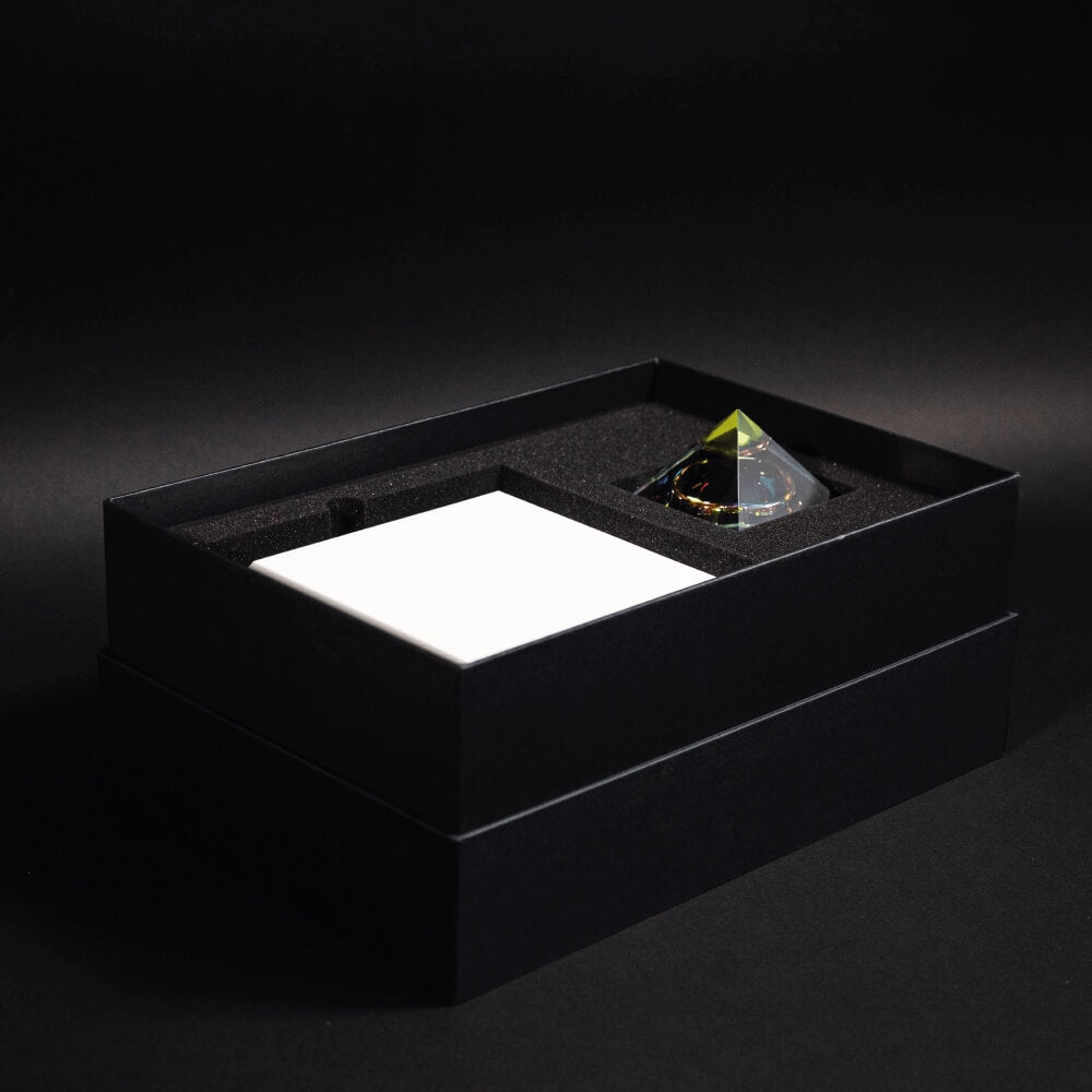 Levitating pyramid Py by Flyte, open packaging photo, side view on a dark background