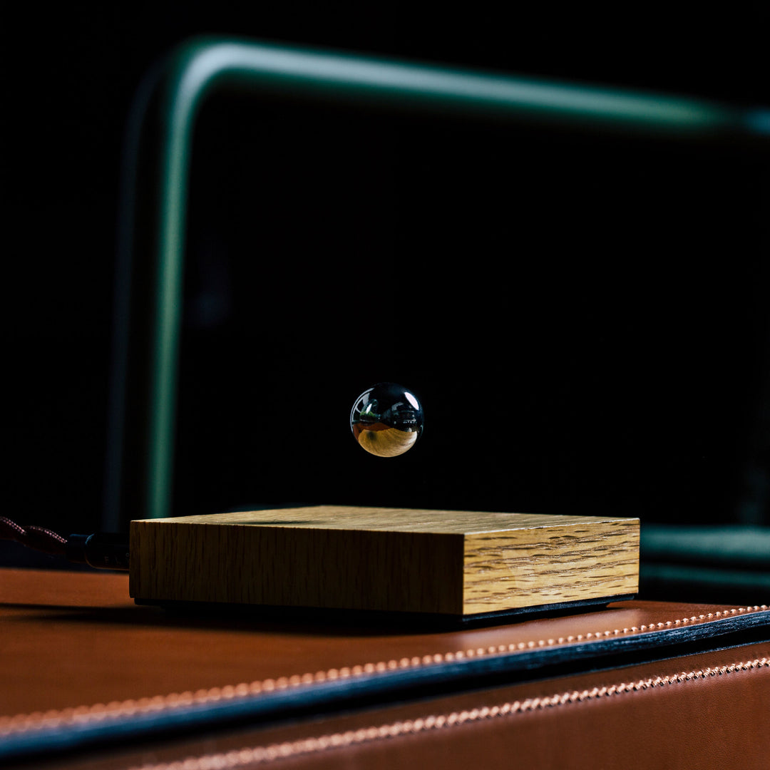 Levitating sphere Buda Ball by Flyte, chrome sphere, oak base option in a interior setting