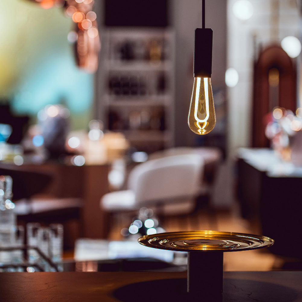 Arc LED light bulb hanging in apartment