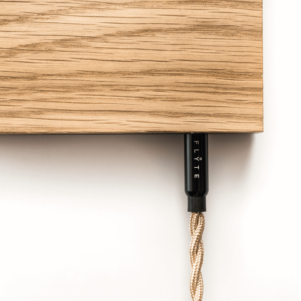 Close up detail photo of Flyte cable plugged in a Flyte oak magnetic base