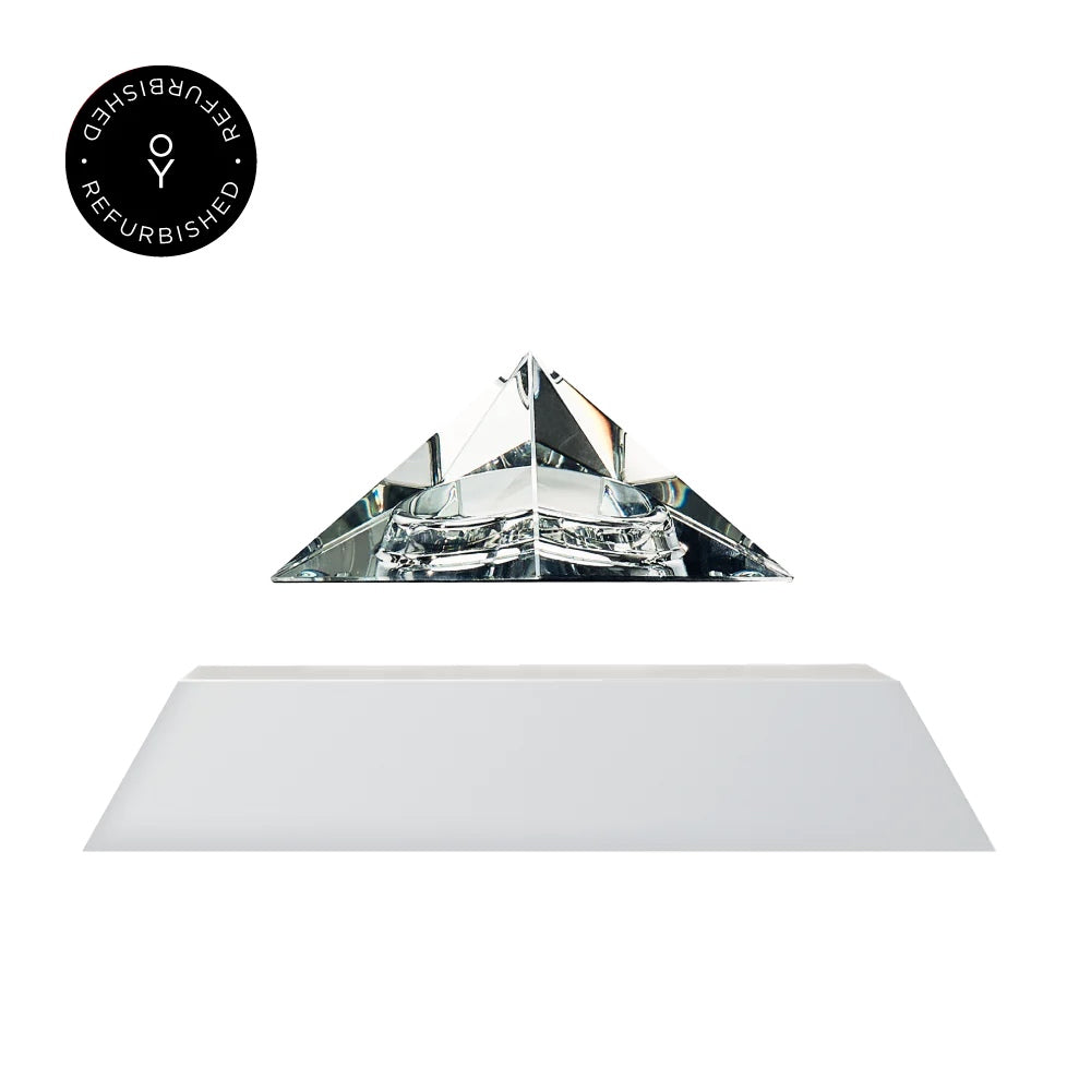 Levitating pyramid Py by Flyte, clear crystal glass top with white magnetic base version, product photo on a white background with refurbished tag
