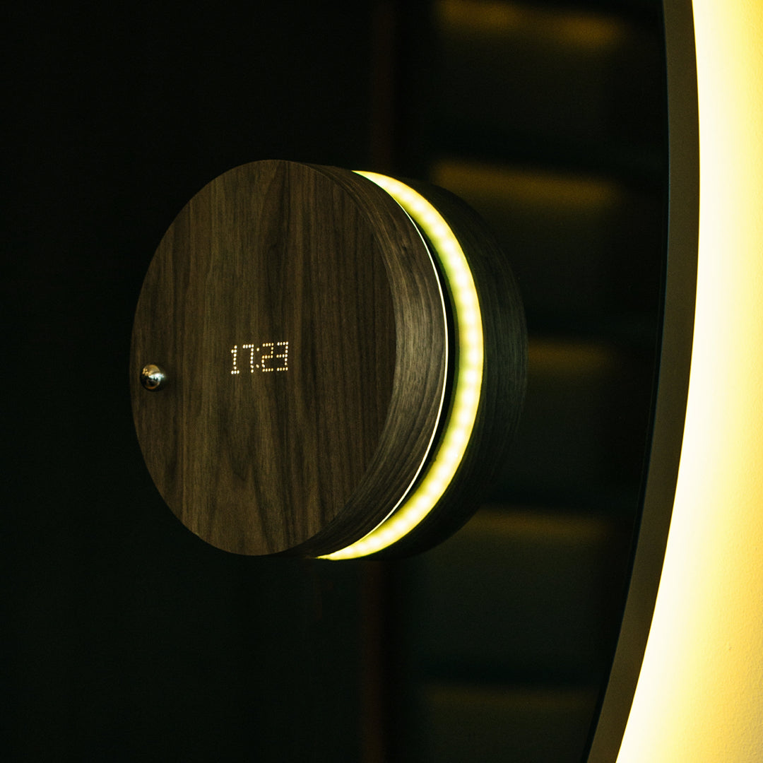 Levitating timepiece Story by Flyte hanging on a mirror 